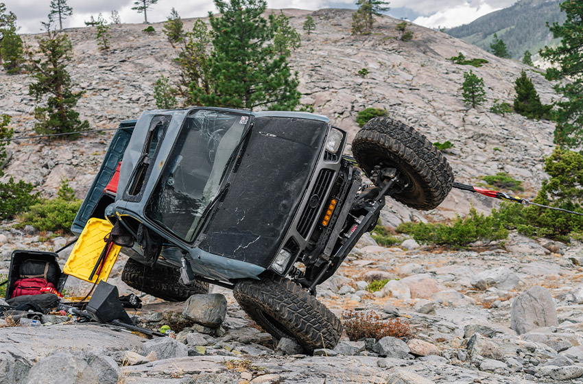Truck being flipped back after flipping over on off-road trail